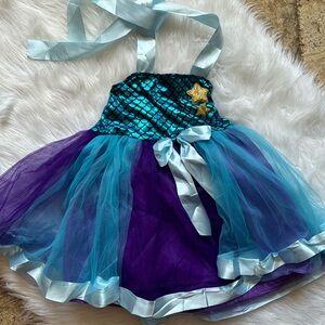 mermaid dazzle tutu dress Shimmer like a mermaid, sparkle like magic  The Mermaid Dazzle Tutu  Dress is made for twirls, glitter, and unforgettable moments  Shop Now:  https://www.miabellebaby.com/collections/girls-dresses /products/girls-sparkle-halter-top-tutu-dress